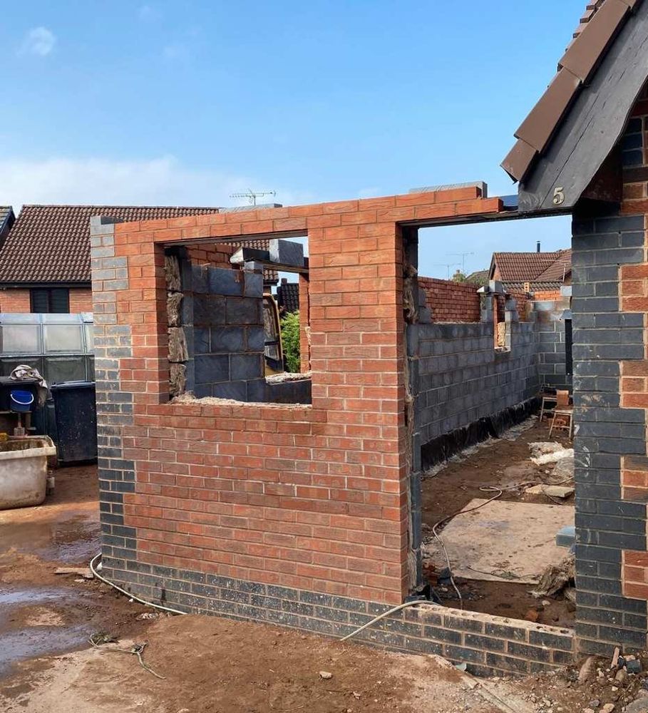 The side of the bungalow in Bedford during the extension build, with new brick and blockwork walls going up
