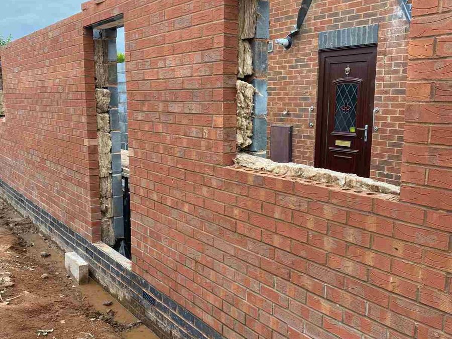 New brickwork with door and window openings during an extension build