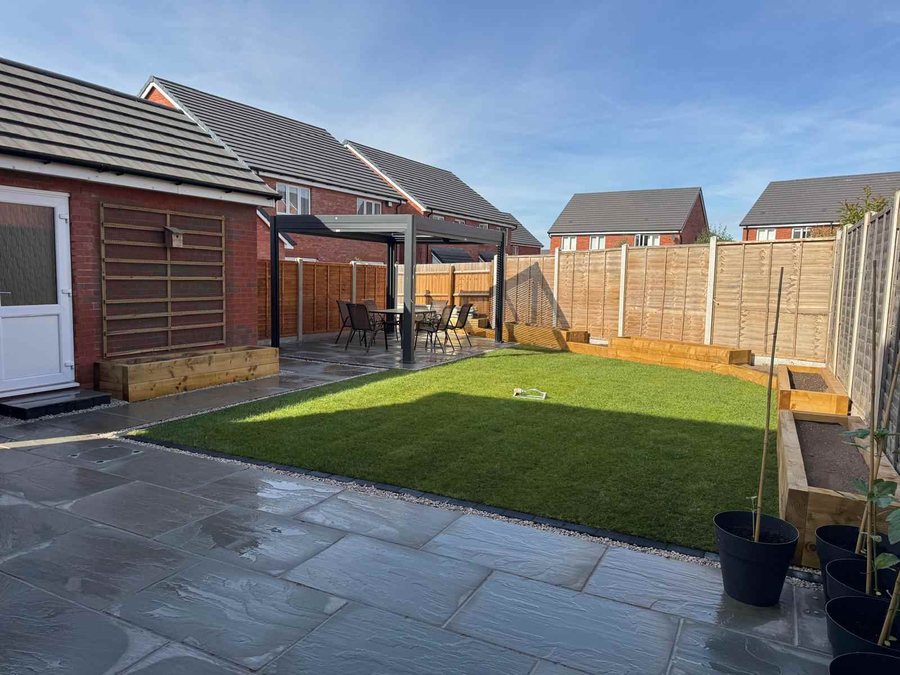Finished garden with sandstone patio, pergola, lawn and raised sleeper beds