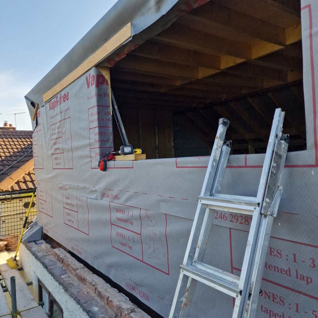 The new dormer framed out and wrapped in breathable membrane, with the window openings formed, on a Little Haywood loft conversion